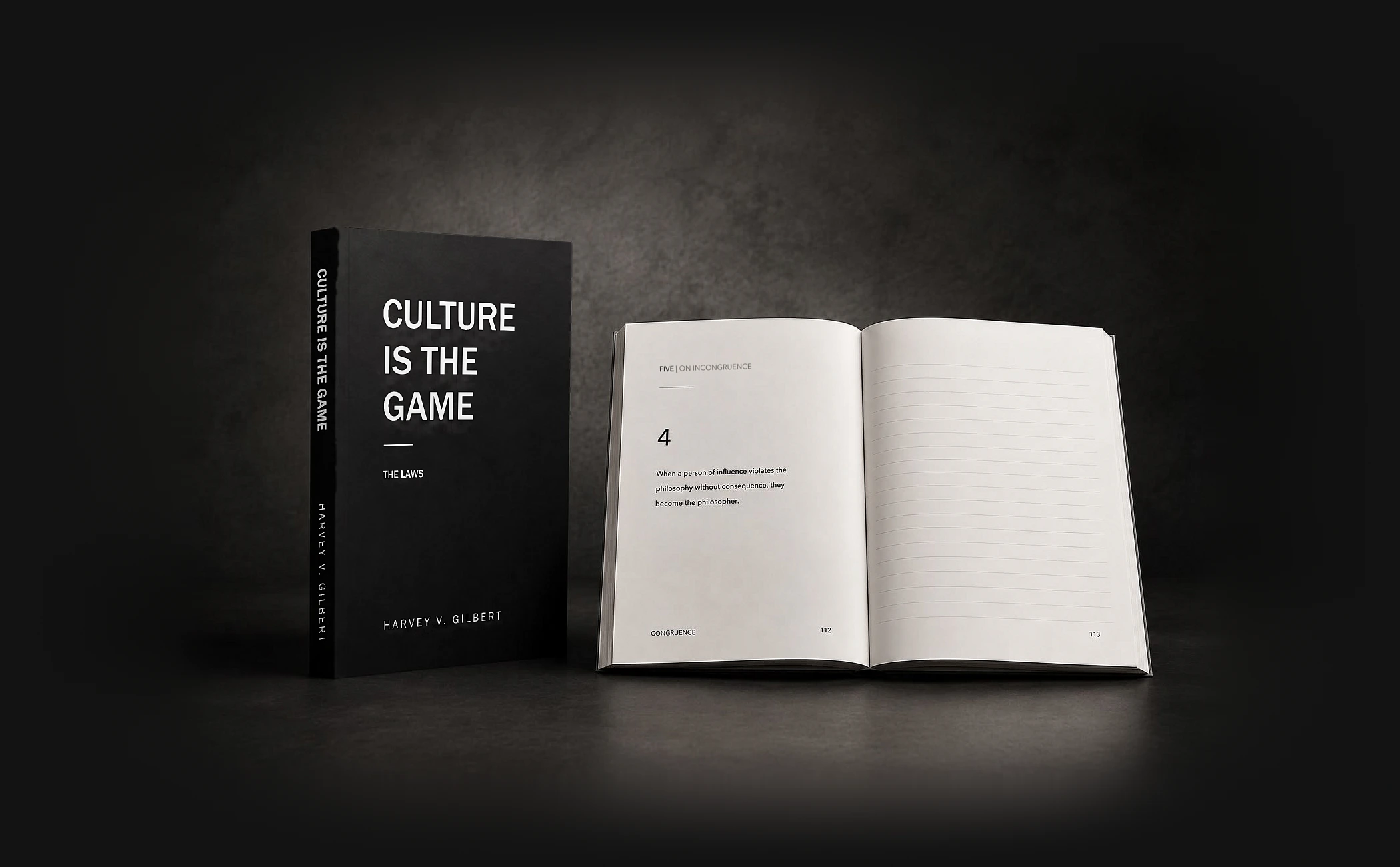 Culture Is The Game, the laws — the notebook closed alongside an open spread showing a law on the left page and ruled lines on the right